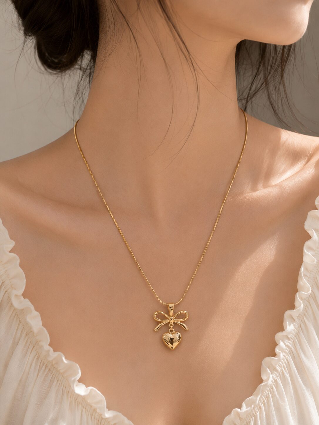 2026/08/1001780439.jpg Elegant Gold Bow Heart Necklace - Image 1