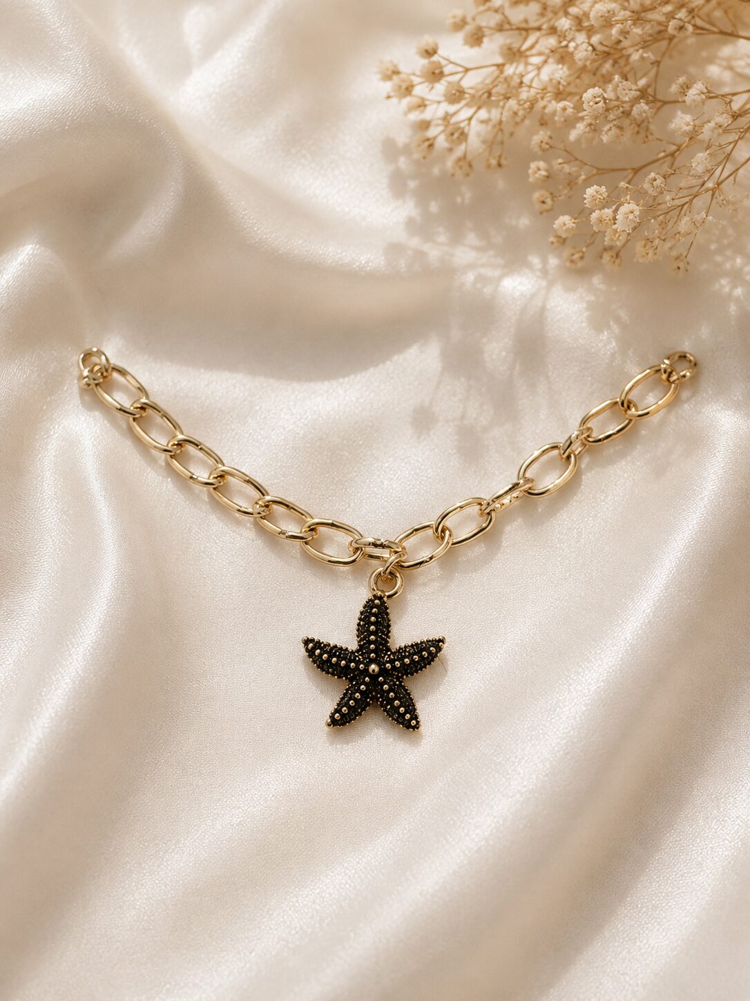 2026/08/1003579632.jpg Black Starfish Charm Gold Chain Bracelet - Image 1