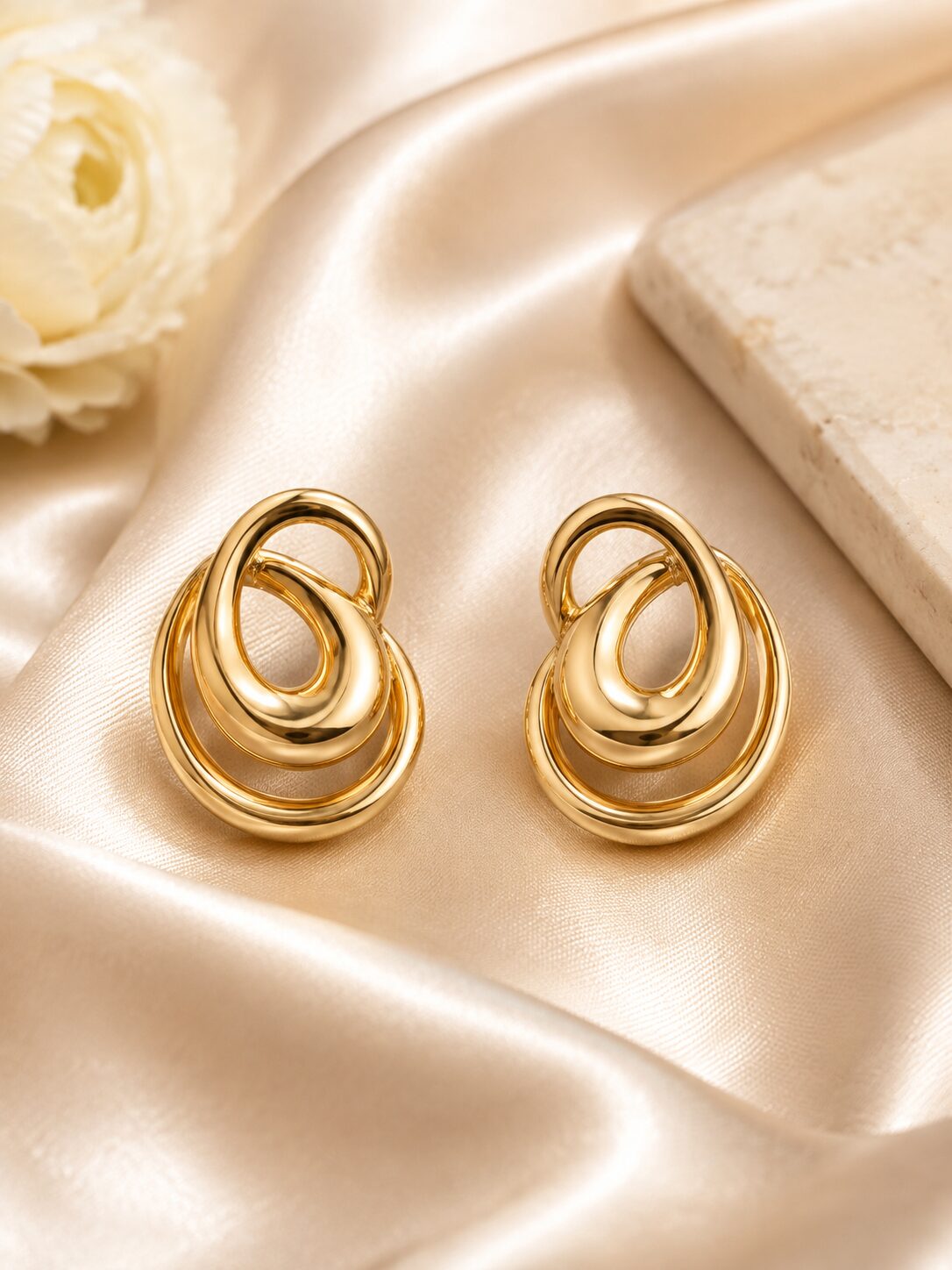 2026/08/18196.jpg Glossy Gold Interlocking Loop Stud Earrings - Image 1