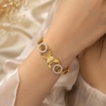 the gold-tone bracelet with heart motifs and crystal-studded circular link ANTI TARNISH bracelet