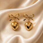 Premium gold bow-and-heart earrings catalogue photo created.
